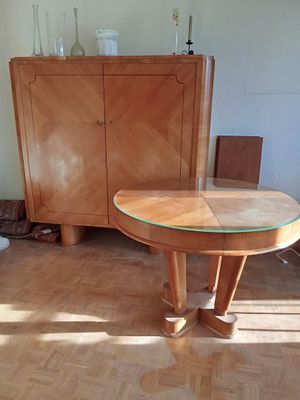 a wooden table with a glass top in the middle of a room