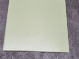 a piece of paper on the floor next to a pair of scissors