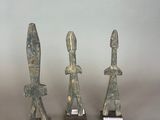 three statues of a man and a woman are on display