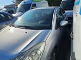 a silver car parked in a parking lot next to other cars