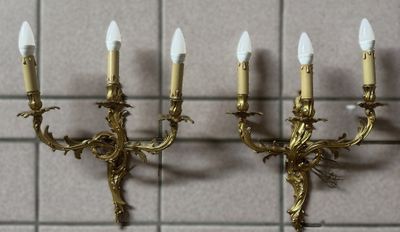 three candles that are on the wall next to each other