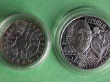 a close up of two coins on a green surface