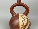 a brown vase with a design on it on a table