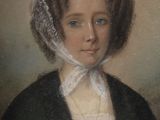 portrait of a woman in a green dress with a white lace over her head