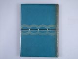 blue leather journal with silver trim on white background