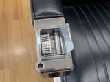 a black leather chair with a metal latch on it