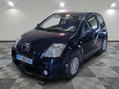 la photo d'une petite voiture bleue sur un sol en damier