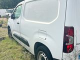a white van that is parked in the grass
