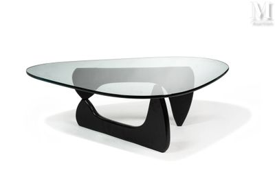 an image of a glass coffee table with black legs and a glass top