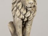 statue of a lion sitting on a wooden table