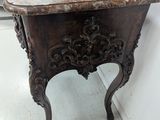 a small table with a marble top in a room