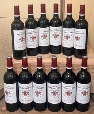 several bottles of red wine are lined up on a wooden shelf