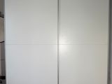 a picture of a white closet with a sliding door