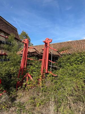 a red machine that is sitting in the grass