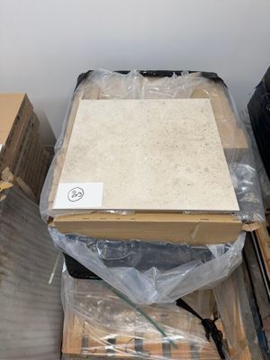 a box with a piece of paper on top of it in the middle of a pile of boxes
