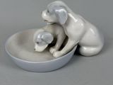 porcelain figurine of a dog and a cat in a bowl