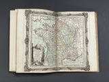 an open book with a map of the country of france