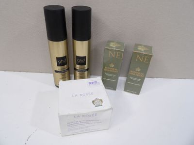 two bottles of perfume and a box of perfume sitting on a table