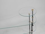 glass and brass coffee table with three glass shelves on each side