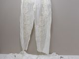 un pantalon blanc suspendu à un cintre accroché au mur