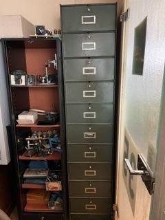 a tall cabinet with many drawers in it