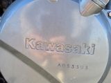 a close up of a motorcycle engine with the words kawasaki on it