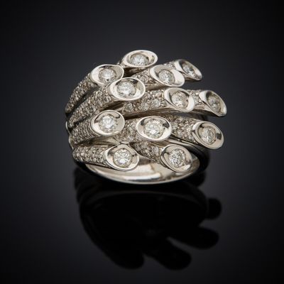 a close up of a diamond ring on a black surface
