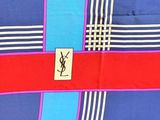 blue, red, and white striped shirt with a monogram on the front