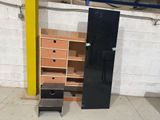 a black refrigerator and a wooden cabinet in a room