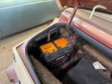 two batteries in the trunk of an old car
