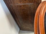 a wooden cabinet with a clock on top of it