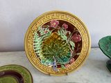 a plate with flowers on it sitting on a table next to other plates