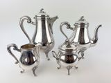 three pieces of silver tea and coffee set on a white background