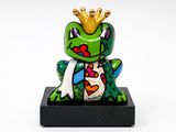figurine of a frog with a crown on its head sitting on a black base