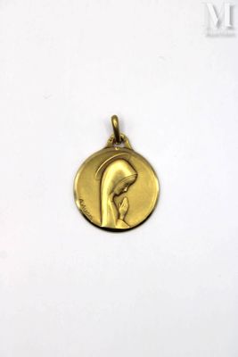 a close up of a gold medal with a woman ' s face on it