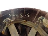 two birds perched on the rim of a wooden wheel
