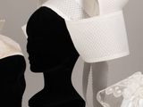 two mannequins with hats on display on a table