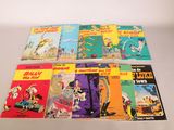 several children ' s books are lined up on a white surface
