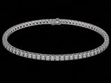 a diamond tennis bracelet on a black background