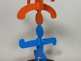 a blue and orange sculpture on a black stand