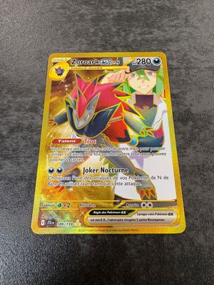 a pokemon card on a table with a black background