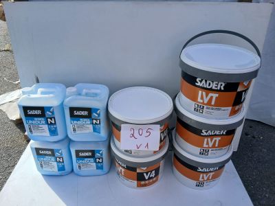 several buckets of paint sitting on a table next to each other