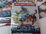 several packs of pokemon trading cards are on a table