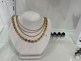 a display of jewelry on display in a glass case