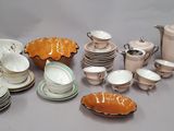 many different types of dishes and cups on the table