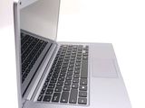 a silver laptop with a black keyboard on a white surface