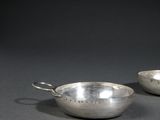 a pair of silver plated bowls with handles and handles
