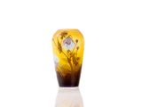 a glass vase with a flower inside of it