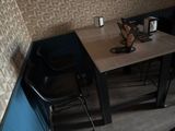 a small table with two chairs and a vase on it