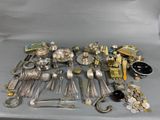 a lot of silverware and other silverware on a table
